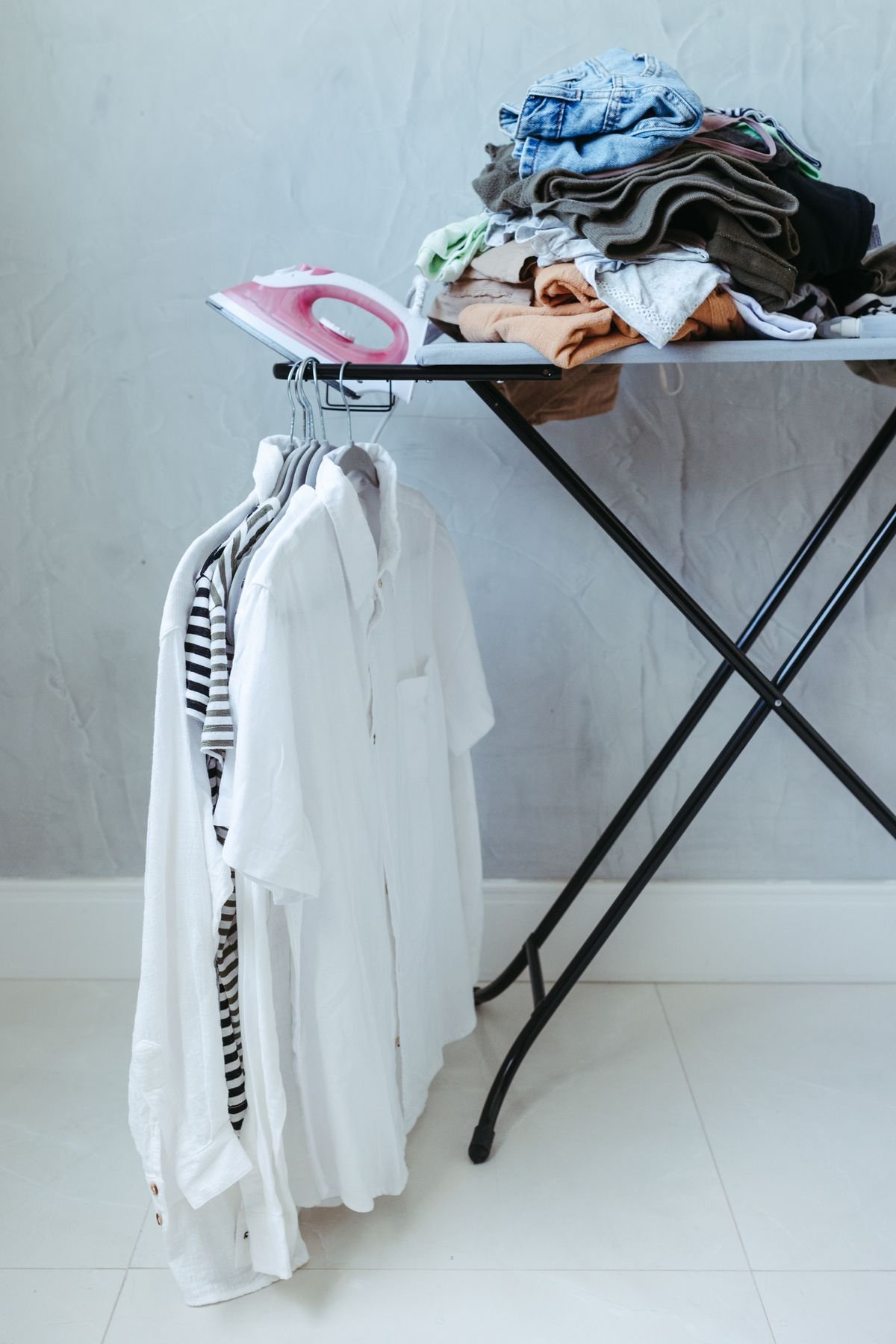 Ironing board with folded clothes